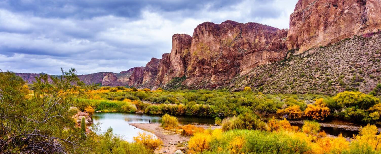 The Salt River and surrounding mountains with fall colored desert shrubs in central Arizona, United States of America